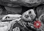 Image of Fallen Japanese soldiers among rocks Iwo Jima, 1945, second 56 stock footage video 65675026273
