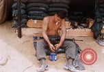 Image of Soldier cleaning his rifle during Operation Somerset Plain Vietnam, 1968, second 15 stock footage video 65675026843