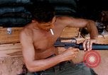 Image of Soldier cleaning his rifle during Operation Somerset Plain Vietnam, 1968, second 31 stock footage video 65675026843