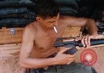 Image of Soldier cleaning his rifle during Operation Somerset Plain Vietnam, 1968, second 33 stock footage video 65675026843