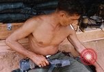 Image of Soldier cleaning his rifle during Operation Somerset Plain Vietnam, 1968, second 36 stock footage video 65675026843