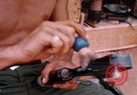 Image of Soldier cleaning his rifle during Operation Somerset Plain Vietnam, 1968, second 46 stock footage video 65675026843