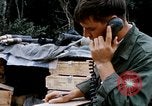 Image of US Soldier speaking on the phone during Operation Somerset Plain Vietnam, 1968, second 14 stock footage video 65675026848