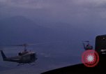 Image of UH-1Ds helicopters flying over the mountains A Shau Valley Vietnam, 1968, second 55 stock footage video 65675026857