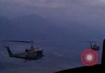 Image of UH-1Ds helicopters flying over the mountains A Shau Valley Vietnam, 1968, second 56 stock footage video 65675026857