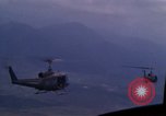 Image of UH-1Ds helicopters flying over the mountains A Shau Valley Vietnam, 1968, second 58 stock footage video 65675026857