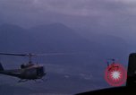 Image of UH-1Ds helicopters flying over the mountains A Shau Valley Vietnam, 1968, second 59 stock footage video 65675026857
