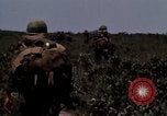 Image of Soldiers walking through the fields during Operation Delaware A Shau Valley Vietnam, 1968, second 61 stock footage video 65675026864