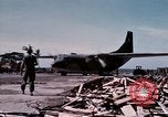Image of UH-1Ds' and UH-1Bs' helicopters landing US troops during Operation Att Dau Tieng Vietnam, 1966, second 4 stock footage video 65675026866