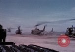 Image of UH-1Ds' and UH-1Bs' helicopters landing US troops during Operation Att Dau Tieng Vietnam, 1966, second 8 stock footage video 65675026866