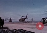 Image of UH-1Ds' and UH-1Bs' helicopters landing US troops during Operation Att Dau Tieng Vietnam, 1966, second 9 stock footage video 65675026866