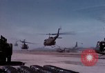 Image of UH-1Ds' and UH-1Bs' helicopters landing US troops during Operation Att Dau Tieng Vietnam, 1966, second 10 stock footage video 65675026866
