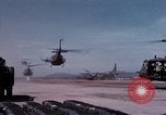 Image of UH-1Ds' and UH-1Bs' helicopters landing US troops during Operation Att Dau Tieng Vietnam, 1966, second 12 stock footage video 65675026866