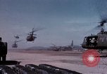 Image of UH-1Ds' and UH-1Bs' helicopters landing US troops during Operation Att Dau Tieng Vietnam, 1966, second 13 stock footage video 65675026866