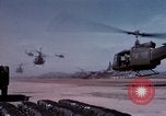 Image of UH-1Ds' and UH-1Bs' helicopters landing US troops during Operation Att Dau Tieng Vietnam, 1966, second 14 stock footage video 65675026866