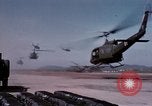 Image of UH-1Ds' and UH-1Bs' helicopters landing US troops during Operation Att Dau Tieng Vietnam, 1966, second 15 stock footage video 65675026866