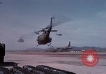 Image of UH-1Ds' and UH-1Bs' helicopters landing US troops during Operation Att Dau Tieng Vietnam, 1966, second 17 stock footage video 65675026866