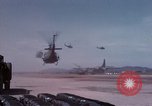 Image of UH-1Ds' and UH-1Bs' helicopters landing US troops during Operation Att Dau Tieng Vietnam, 1966, second 18 stock footage video 65675026866