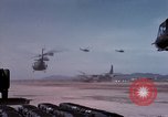 Image of UH-1Ds' and UH-1Bs' helicopters landing US troops during Operation Att Dau Tieng Vietnam, 1966, second 19 stock footage video 65675026866