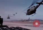 Image of UH-1Ds' and UH-1Bs' helicopters landing US troops during Operation Att Dau Tieng Vietnam, 1966, second 20 stock footage video 65675026866