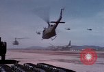 Image of UH-1Ds' and UH-1Bs' helicopters landing US troops during Operation Att Dau Tieng Vietnam, 1966, second 21 stock footage video 65675026866
