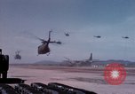Image of UH-1Ds' and UH-1Bs' helicopters landing US troops during Operation Att Dau Tieng Vietnam, 1966, second 22 stock footage video 65675026866