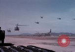 Image of UH-1Ds' and UH-1Bs' helicopters landing US troops during Operation Att Dau Tieng Vietnam, 1966, second 23 stock footage video 65675026866