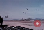 Image of UH-1Ds' and UH-1Bs' helicopters landing US troops during Operation Att Dau Tieng Vietnam, 1966, second 24 stock footage video 65675026866