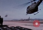 Image of UH-1Ds' and UH-1Bs' helicopters landing US troops during Operation Att Dau Tieng Vietnam, 1966, second 25 stock footage video 65675026866