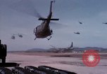 Image of UH-1Ds' and UH-1Bs' helicopters landing US troops during Operation Att Dau Tieng Vietnam, 1966, second 26 stock footage video 65675026866