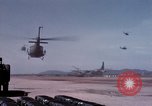 Image of UH-1Ds' and UH-1Bs' helicopters landing US troops during Operation Att Dau Tieng Vietnam, 1966, second 27 stock footage video 65675026866