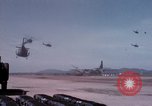 Image of UH-1Ds' and UH-1Bs' helicopters landing US troops during Operation Att Dau Tieng Vietnam, 1966, second 28 stock footage video 65675026866
