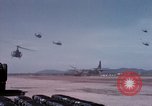 Image of UH-1Ds' and UH-1Bs' helicopters landing US troops during Operation Att Dau Tieng Vietnam, 1966, second 29 stock footage video 65675026866
