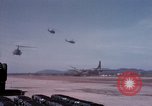 Image of UH-1Ds' and UH-1Bs' helicopters landing US troops during Operation Att Dau Tieng Vietnam, 1966, second 30 stock footage video 65675026866