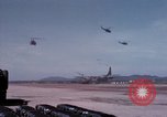 Image of UH-1Ds' and UH-1Bs' helicopters landing US troops during Operation Att Dau Tieng Vietnam, 1966, second 33 stock footage video 65675026866