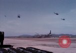 Image of UH-1Ds' and UH-1Bs' helicopters landing US troops during Operation Att Dau Tieng Vietnam, 1966, second 34 stock footage video 65675026866