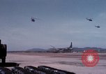 Image of UH-1Ds' and UH-1Bs' helicopters landing US troops during Operation Att Dau Tieng Vietnam, 1966, second 35 stock footage video 65675026866