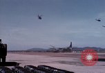 Image of UH-1Ds' and UH-1Bs' helicopters landing US troops during Operation Att Dau Tieng Vietnam, 1966, second 36 stock footage video 65675026866