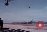 Image of UH-1Ds' and UH-1Bs' helicopters landing US troops during Operation Att Dau Tieng Vietnam, 1966, second 39 stock footage video 65675026866