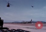 Image of UH-1Ds' and UH-1Bs' helicopters landing US troops during Operation Att Dau Tieng Vietnam, 1966, second 40 stock footage video 65675026866