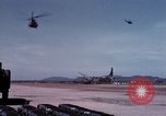 Image of UH-1Ds' and UH-1Bs' helicopters landing US troops during Operation Att Dau Tieng Vietnam, 1966, second 41 stock footage video 65675026866