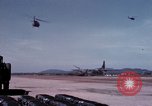 Image of UH-1Ds' and UH-1Bs' helicopters landing US troops during Operation Att Dau Tieng Vietnam, 1966, second 42 stock footage video 65675026866