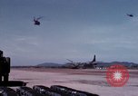 Image of UH-1Ds' and UH-1Bs' helicopters landing US troops during Operation Att Dau Tieng Vietnam, 1966, second 43 stock footage video 65675026866
