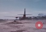 Image of UH-1Ds' and UH-1Bs' helicopters landing US troops during Operation Att Dau Tieng Vietnam, 1966, second 51 stock footage video 65675026866