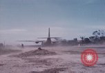 Image of UH-1Ds' and UH-1Bs' helicopters landing US troops during Operation Att Dau Tieng Vietnam, 1966, second 52 stock footage video 65675026866