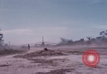 Image of UH-1Ds' and UH-1Bs' helicopters landing US troops during Operation Att Dau Tieng Vietnam, 1966, second 54 stock footage video 65675026866