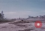 Image of UH-1Ds' and UH-1Bs' helicopters landing US troops during Operation Att Dau Tieng Vietnam, 1966, second 55 stock footage video 65675026866