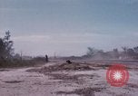 Image of UH-1Ds' and UH-1Bs' helicopters landing US troops during Operation Att Dau Tieng Vietnam, 1966, second 57 stock footage video 65675026866