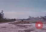 Image of UH-1Ds' and UH-1Bs' helicopters landing US troops during Operation Att Dau Tieng Vietnam, 1966, second 58 stock footage video 65675026866