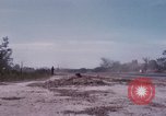 Image of UH-1Ds' and UH-1Bs' helicopters landing US troops during Operation Att Dau Tieng Vietnam, 1966, second 59 stock footage video 65675026866